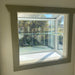 Large Janco Garden Window with empty glass shelf installed and mounting brackets visible