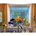 White Janco Garden Window installed above a kitchen sink and used to display flowers and décor