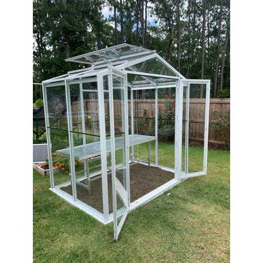 Janco Sago 5' x 8' glass greenhouse with white frame, double doors open and optional interior bench