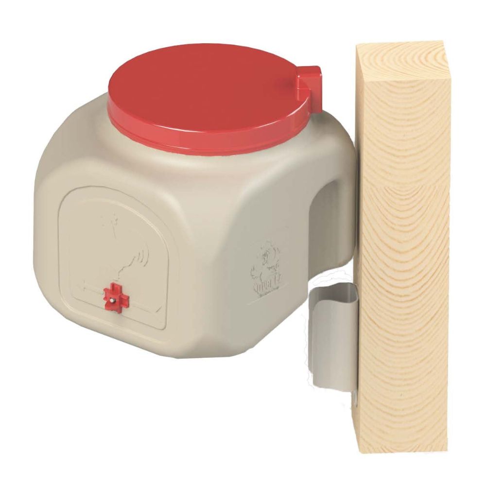 A plastic chicken coop waterer with a red lid and red spout, demonstrating the mounting bracket on a wooden board.