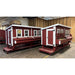 Two red and white chicken coops with four windows on pallets, fully assembled at warehouse.