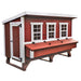 Red and white wooden chicken coop with three windows and a large access door.
