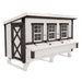 White with black trim wooden chicken coop with three windows, nesting box, and large access door.