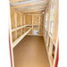 Wooden interior of XL chicken coop with roosting bars on the left and nesting box openings on the right.