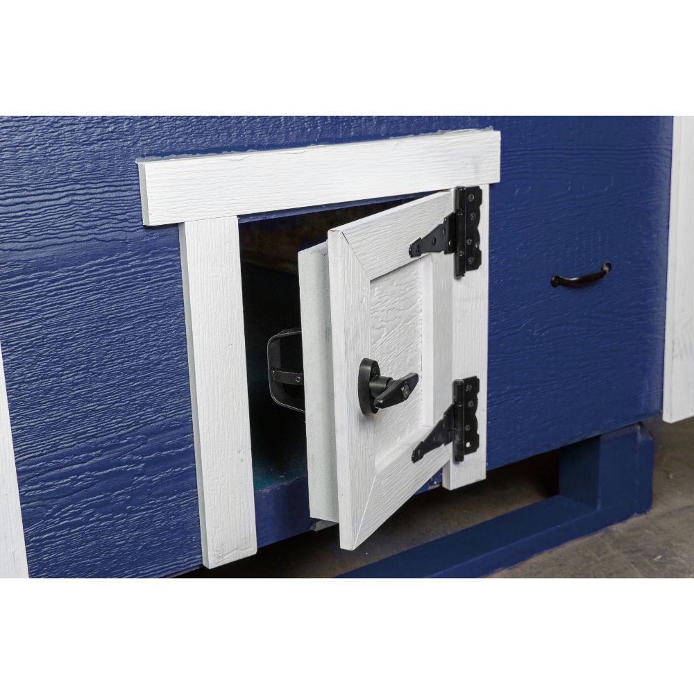 A close-up of a chicken access door with black hardware, slightly open.