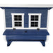 A blue and white wooden chicken coop with two white-framed windows and a nesting box.