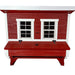 A red wooden chicken coop with white trim, featuring two small window-style doors and a front nesting box.