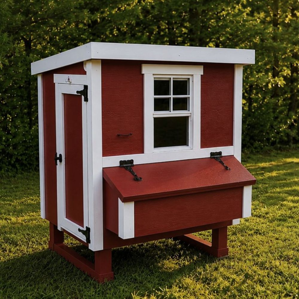 Red and white chicken coop, outdoors, showing large entry door.