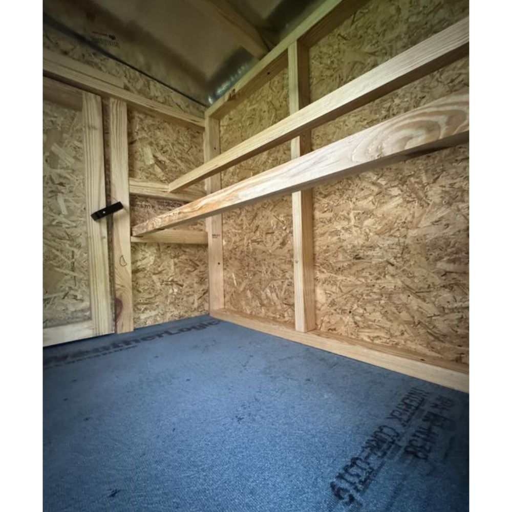 Wooden interior showing the two roosting bars for the chickens.