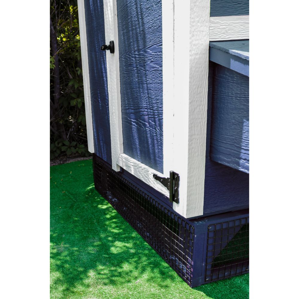 Corner view of blue wooden panels and black mesh elevating a blue and white chicken coop.