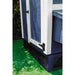 Corner view of blue wooden panels and black mesh elevating a blue and white chicken coop.