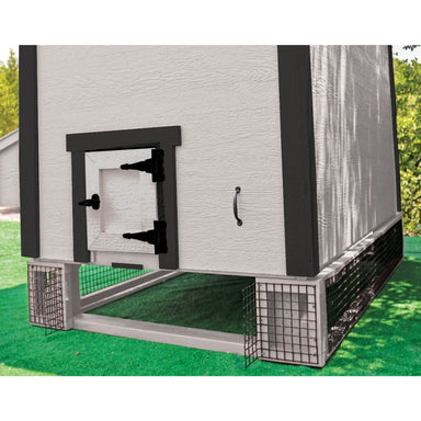 Wooden panels with black mesh elevating medium chicken coop and an opening in the front.