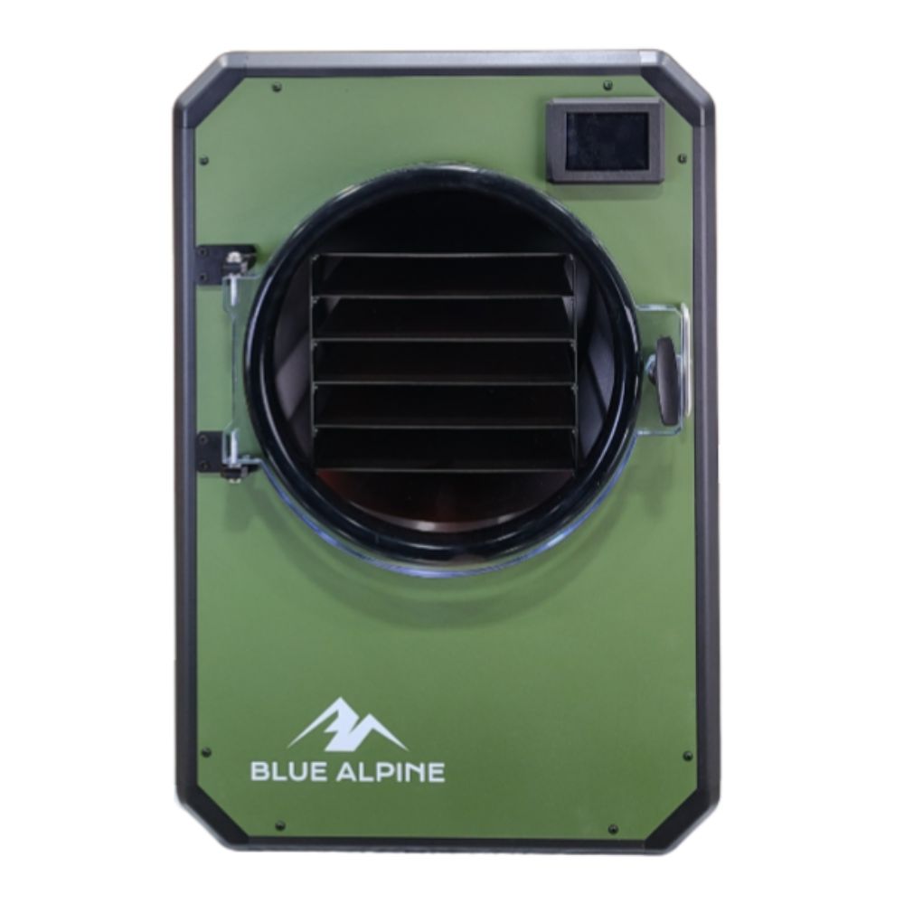 Medium Elite freeze dryer by Blue Alpine, featuring a forest green front panel with a circular transparent door, black interior racks, and a small digital display screen in the upper right corner.