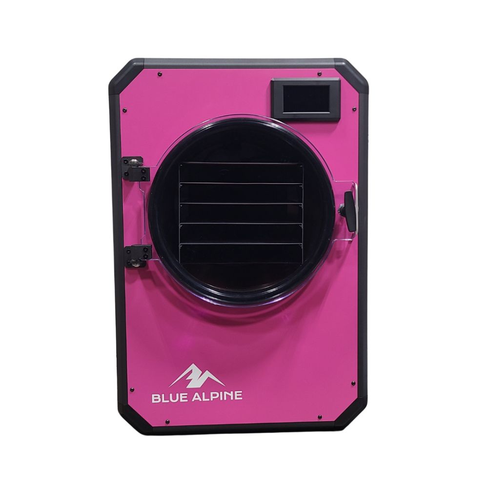 Medium Elite freeze dryer by Blue Alpine, featuring a bright pink front panel with a circular transparent door, black interior racks, and a small digital display screen in the upper right corner.