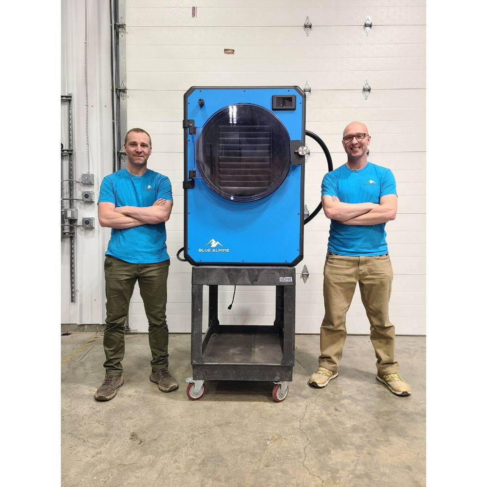 Blue Alpine XL Commercial Freeze Dryer with two men standing next to it for size perspective.