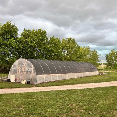 Bootstrap Farmer 10' Wide DIY Greenhouse outside view on grass with a grey sky.