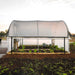 Side view of Bootstrap Farmer 10' x 12' Hobby Greenhouse with roll-up sides fully open for ventilation