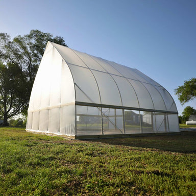 Bootstrap Farmer DIY Gothic Greenhouse shown from the side with greenhouse plastic covering and tall Gothic arch profile
