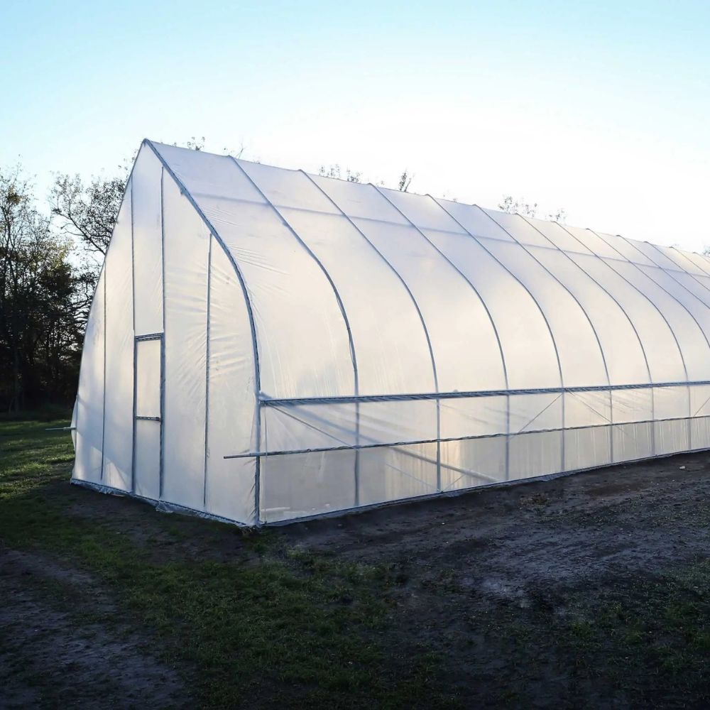 Right side of the Bootstrap Farmer Gothic High Tunnel with the light reflecting off of it.