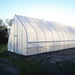 Right side of the Bootstrap Farmer Gothic High Tunnel with the light reflecting off of it.