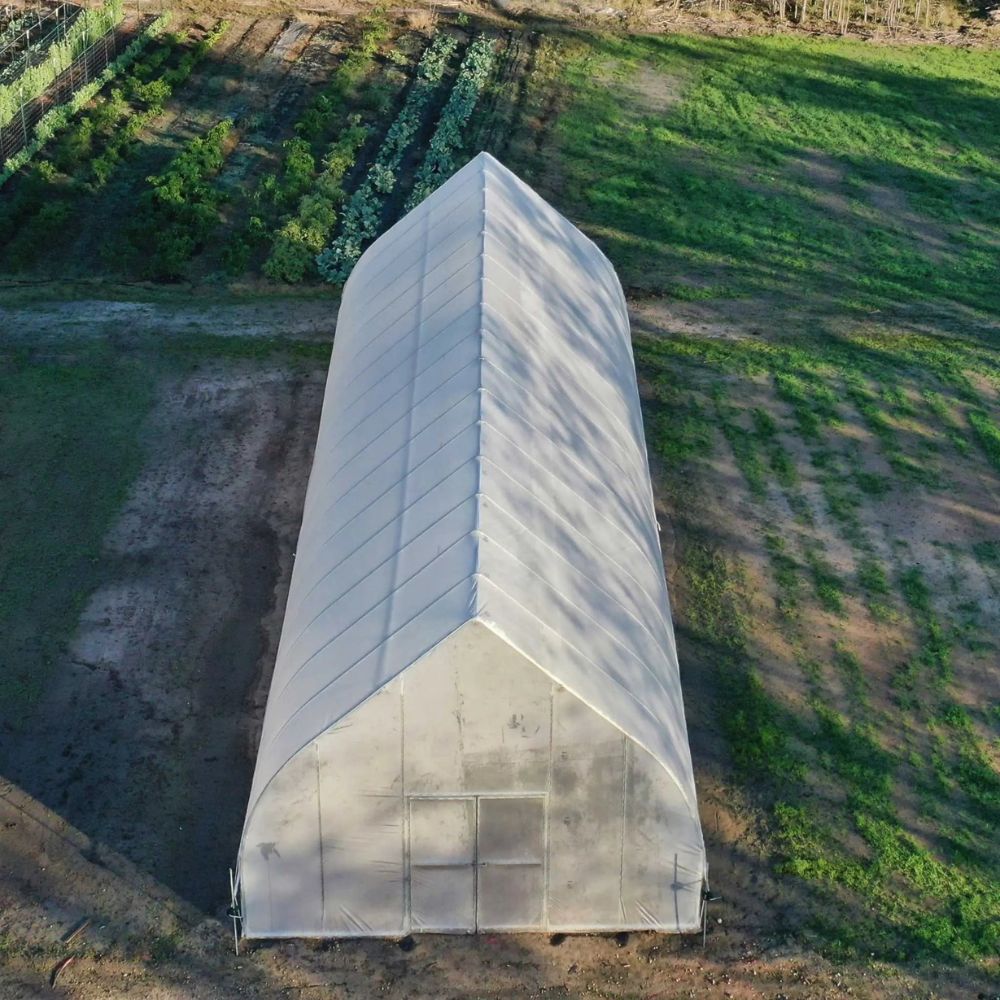 Overhead view of the Bootstrap Farmer Gothic High Tunnel with rows of crops.