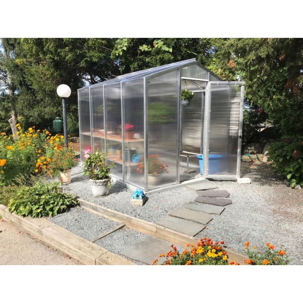 Janco Palmetto 8' x 10' polycarbonate greenhouse installed in a backyard garden.