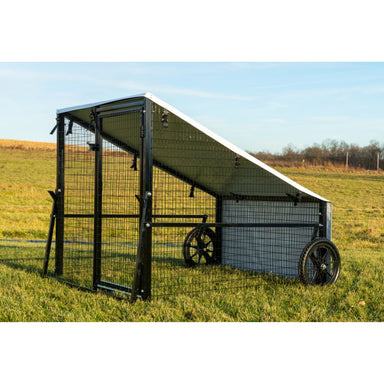 Porta Coop 4' × 5' Haven mobile chicken coop with wire frame, tarp roof, and wheels