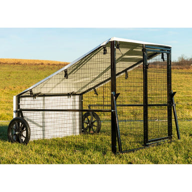 Side view of Porta Coop 4' × 5' Haven mobile chicken coop with wire frame, tarp roof, and wheels
