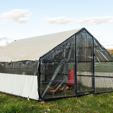Porta Coop Heritage mobile chicken coop with clear Winter Kit enclosure installed