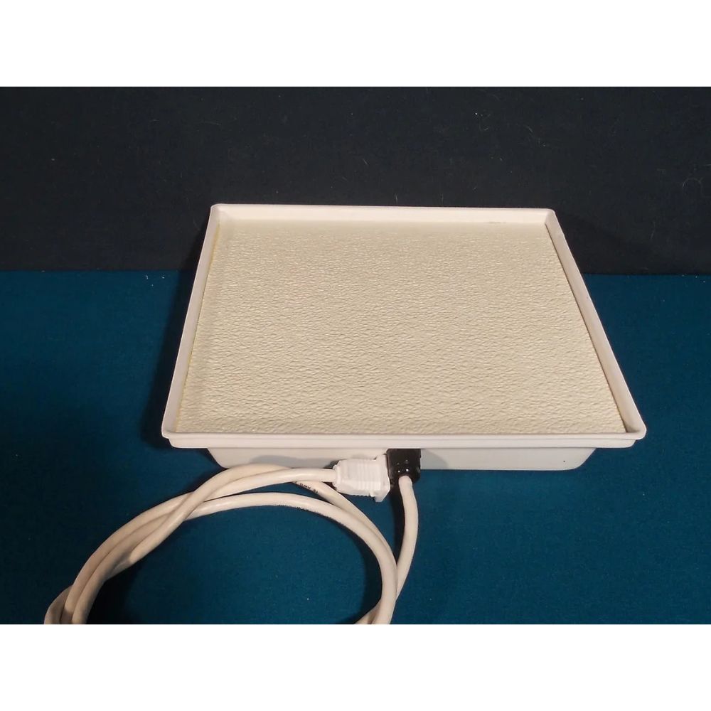 Sweeter Heater Coop & Brooder Heater heating surface with attached power cord.